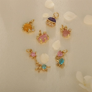 Gold-plated animal pendants with colorful crystals and opal on elegant silk background
