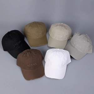 Detailed flat lay of six distressed cotton baseball caps in multiple colors with embroidery