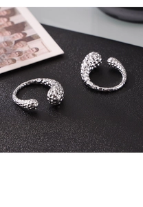 Detailed view of silver rings featuring irregular hammered texture and asymmetric design