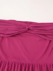 Detail of fuchsia mesh dress featuring a knotted chest design and sheer fabric texture