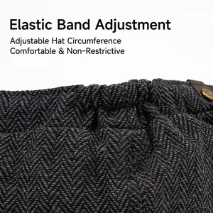 Dark grey herringbone flat cap with adjustable elastic band and metal side buckle