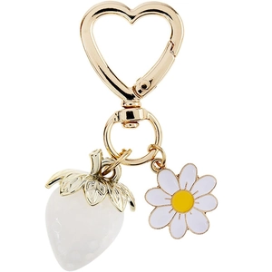 Detail of gold heart clasp with 3D white strawberry and daisy flower charms