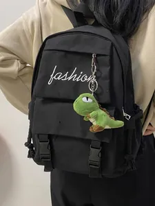 Large black canvas backpack with fashion text and green dinosaur keychain for students