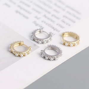 Detail view of gold and silver plated s925 silver hoop earrings with inset pearls