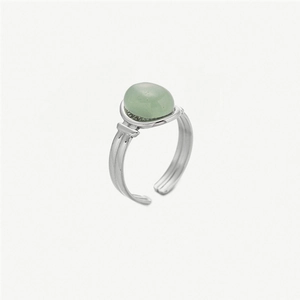 Macro detail of retro stainless steel ring with light green stone and textured band