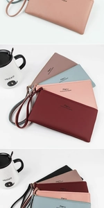 Detail of colorful faux leather wallets with wristlets and premium embossed logo