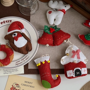 Flat lay of colorful felt Christmas ornaments including stockings and reindeer shapes