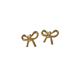 Elegant gold bow earrings with high-gloss metallic finish on a clean white background
