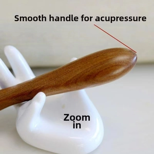 Macro detail of the smooth green sandalwood massage comb handle for acupoint therapy