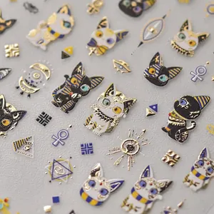 Golden Egyptian cat nail stickers with embossed metallic ancient symbols and ankh motifs