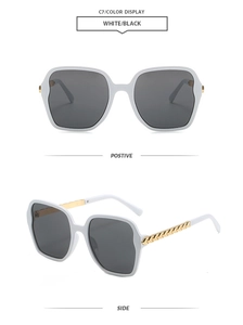 Front and side view of white polygon oversized sunglasses with gold chain detail