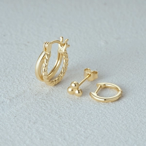 Detailed close-up of 925 sterling silver gold geometric earrings set with S925 hallmark