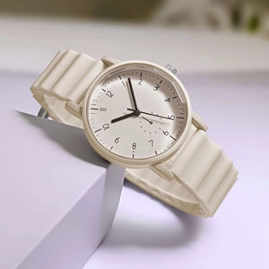 Detail of quartz watch featuring wavy texture silicone strap and minimalist numeric dial