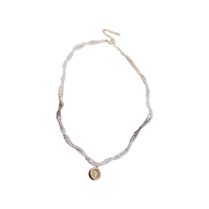 Double-layer pearl necklace with a gold octagonal star pendant and twisted rope chain