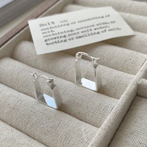 Macro view showing the S925 hallmark on silver rectangular tube hoop earrings