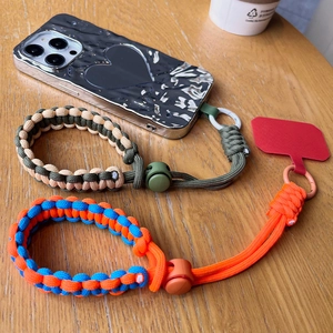 Adjustable braided paracord wrist phone lanyard with metal ring and connector pad