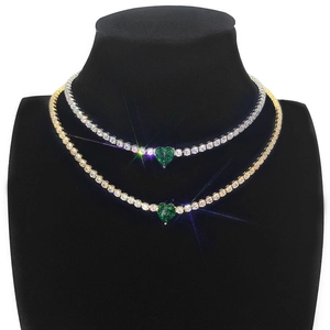Green heart-cut emerald tennis necklaces in 18k gold and silver on black model stand