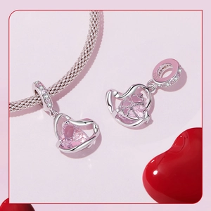 Macro shot of S925 sterling silver pink heart charm with zircon on a braided bracelet