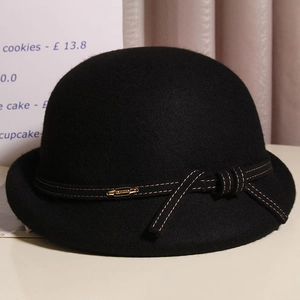 Elegant black wool felt cloche hat with a delicate bow and gold accent charm