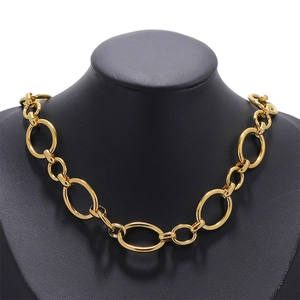 Detailed view of thick gold O-chain necklace on a black jewelry bust display stand
