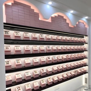 Pink drawer boxes for press-on nails neatly displayed on professional showroom shelves