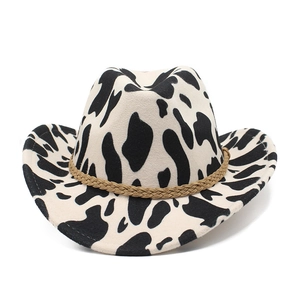 Detail of cow print cowboy hat featuring a braided brown band and rolled brim texture