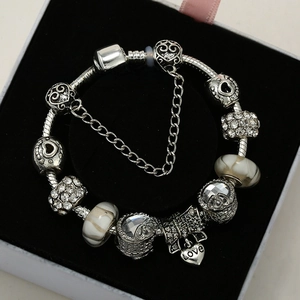 Close-up of beaded charm bracelet with LOVE pendant and heart charms in a gift box