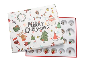 Detailed view of Christmas advent calendar with 24 DIY metal charms for kids bracelets