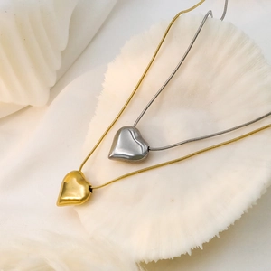 Minimalist 18k gold and silver heart pendant necklaces with sleek snake chains for women
