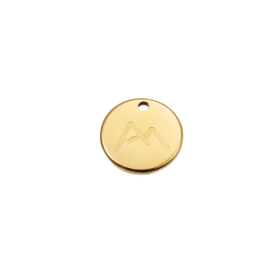 Macro view of a round 18K gold-plated stainless steel charm with mountain engraving