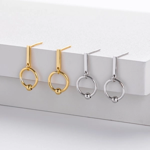 Detailed view of geometric hollow double-loop hoop earrings in gold and silver finishes
