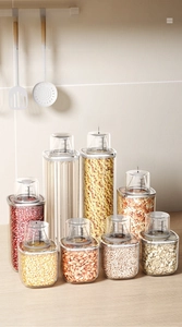 Transparent food storage jars with measuring cup lids for kitchen organization