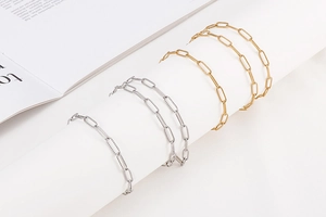 Detailed shot of gold and silver textured paperclip chain necklace and bracelet set