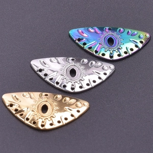 Macro view of evil eye stainless steel charms in rainbow, silver, and gold finishes