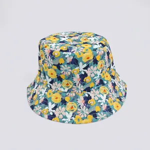 Top view of floral bucket hat featuring yellow flower patterns on a teal canvas surface