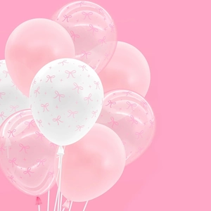 Detailed cluster of pink and white latex balloons with bow prints for party decor