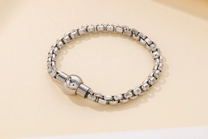 Detailed view of silver square box chain bracelet with magnetic ball clasp closure
