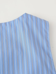Detail shot of the vertical blue and white striped cotton fabric texture and stitching