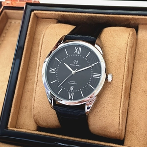 Close-up of quartz watch with black dial and leather strap in a premium gift box