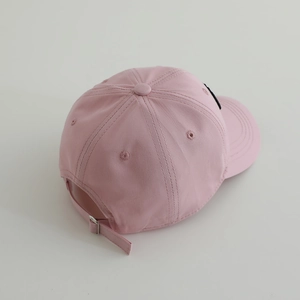Detailed back view of pink cotton baseball cap featuring adjustable strap and metal buckle