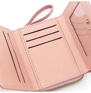 Close-up of pink PU leather tri-fold wallet showing multiple card slots and clear ID window