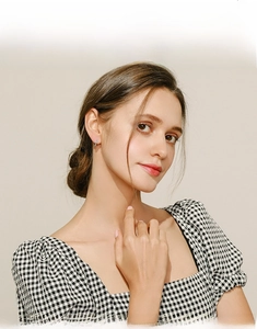 Model wearing minimalist S925 silver turquoise hoop earrings with a modern design