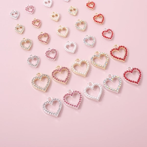Detailed view of Y2K hollow heart charms with rhinestones for DIY nail art and jewelry