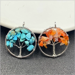 Detail of tree of life pendants with colorful natural stones and silver wire wrapping