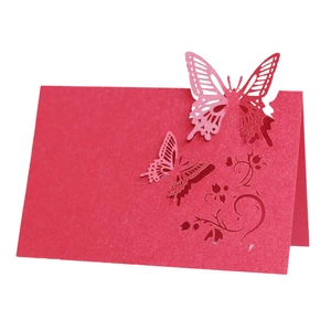 Detailed laser cut red butterfly place card with intricate floral patterns for weddings