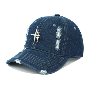 Distressed blue denim baseball cap with silver metal star rivet and frayed hole details