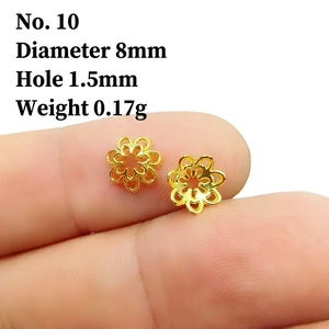 Detailed macro view of 8mm gold hollow petal bead cap on a fingertip for DIY jewelry