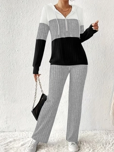 Detailed texture of knitted ribbed fabric on color-block hooded sweatshirt and pants set