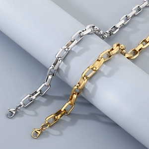 Detailed view of silver and gold square box chain bracelets with lobster clasps