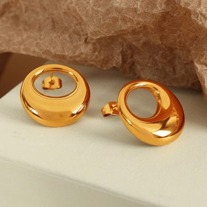 Minimalist gold hollow oval stud earrings on aesthetic brown textured paper background